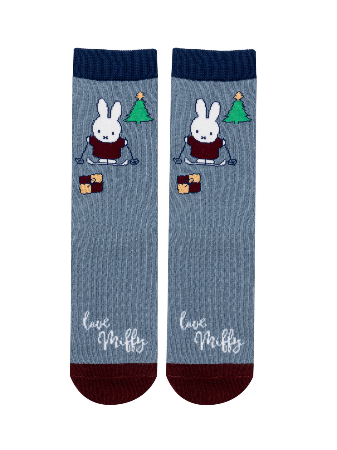 Miffy™ Christmas Socks in blue, with Miffy on her skis beside a Christmas tree and a stack of presents