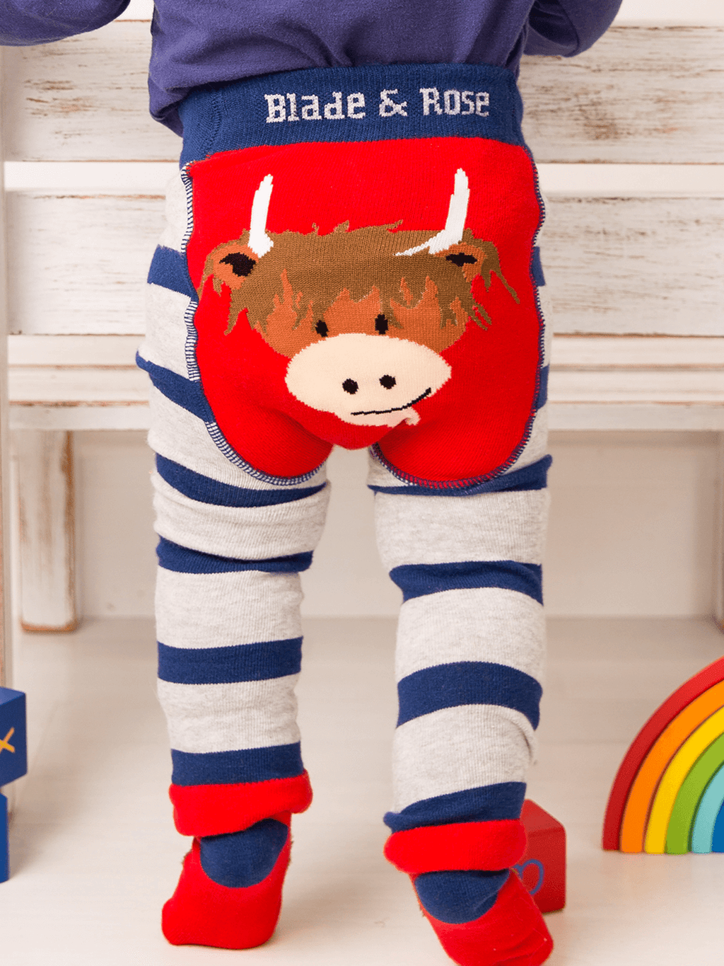 Children's leggings with a cow design and 'Blade & Rose' branding on a wooden floor.