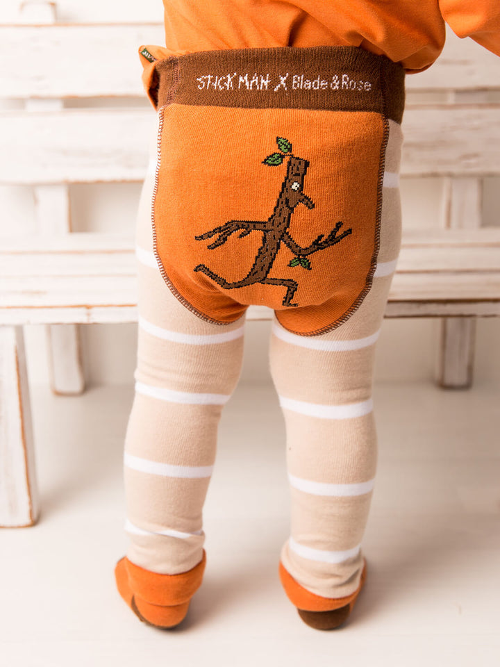 Child wearing orange pants with stick figure design and 'Stick Man X Blade & Rose' branding.